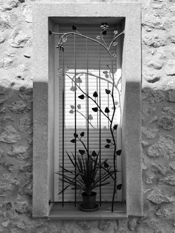 Window in the afternoon shadow in black and white
